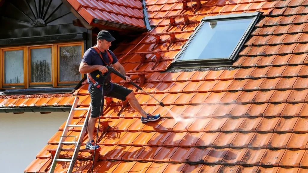 A man is implementing cleaning services on roof in Georgetown, TX