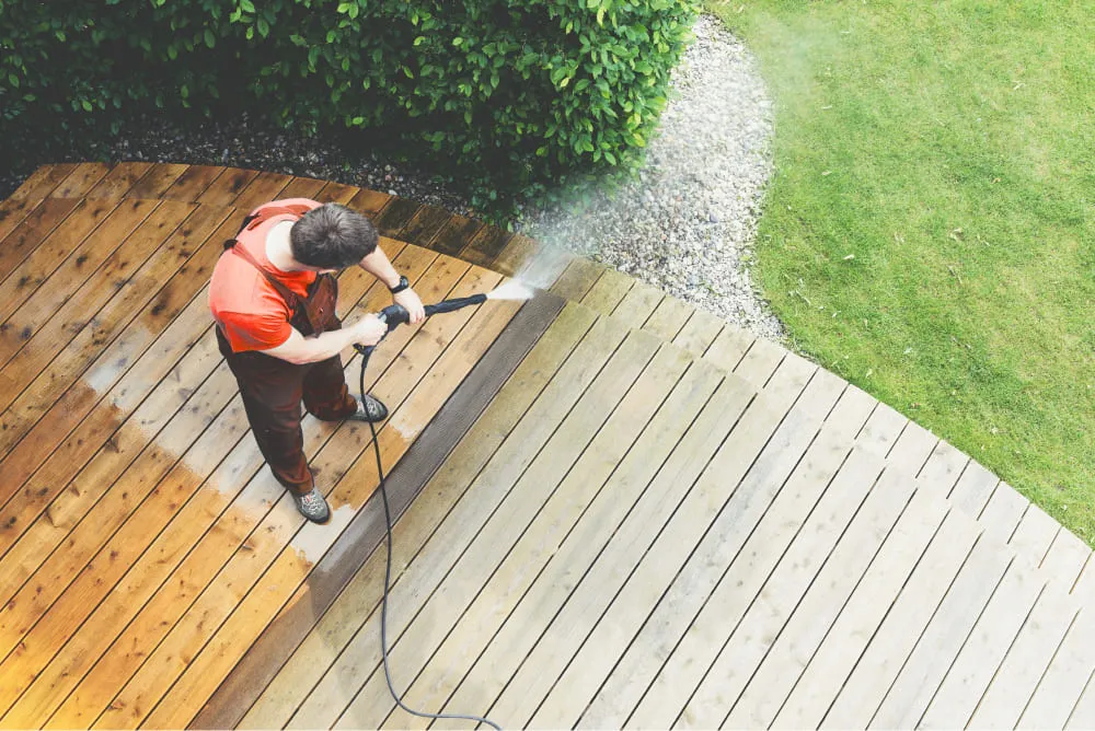 A man is cleaning the roof for Shingle roof repair services in Manor, TX