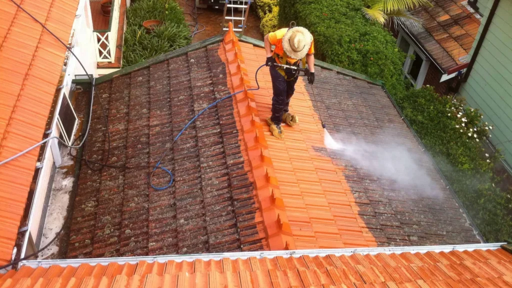 A man is performing roof cleaning service in Georgetown, TX