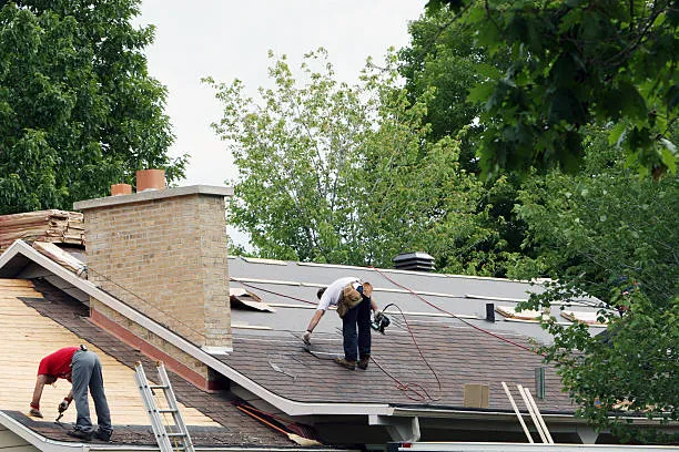 Two professionals are performing roof installation services in Taylor, TX.