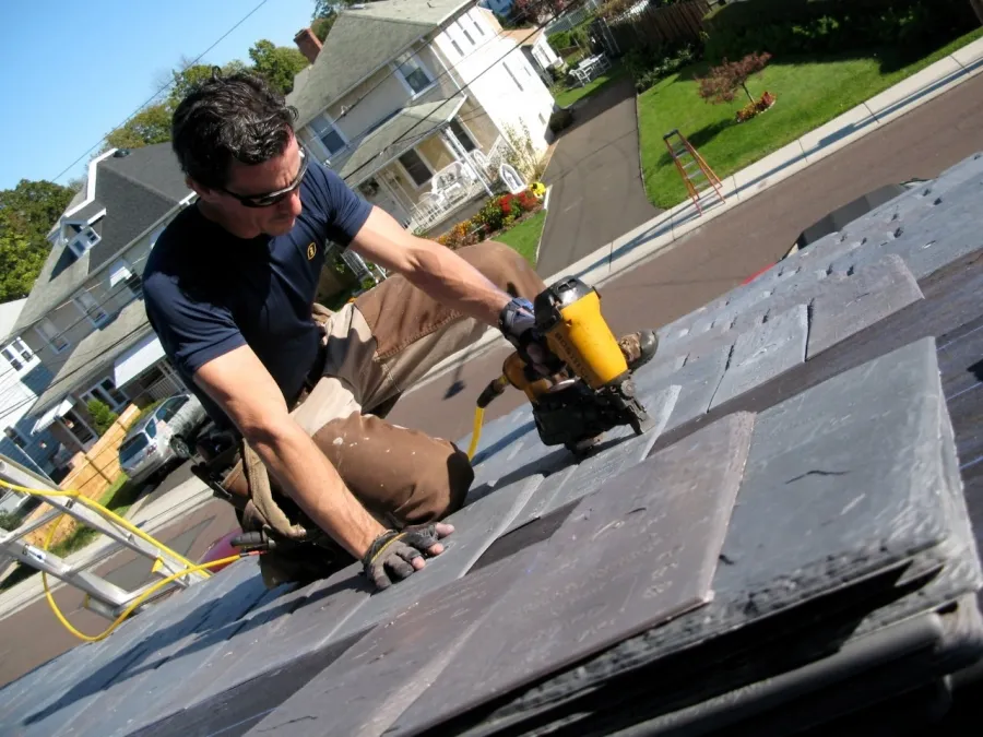 A handyman is doing roof repair services in Manor, TX