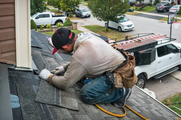 A professional roofer repairing a damaged roof in in Pflugerville, TX