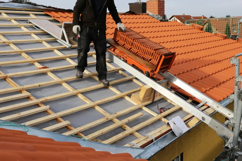 A worker is bringing shingles to repair roof in Manor, TX