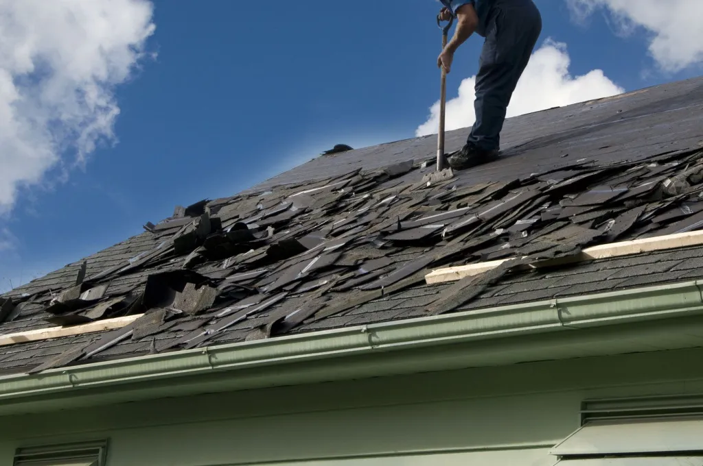 A man is clearing waste from roof after installation in Leander, TX