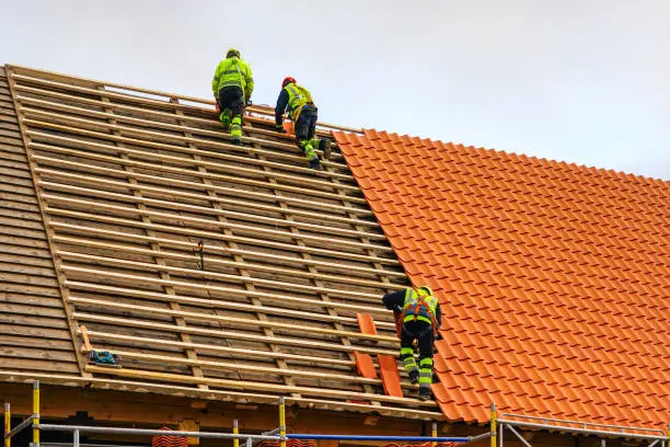 Skilled roofing team performing a roof replacement in in Pflugerville, TX