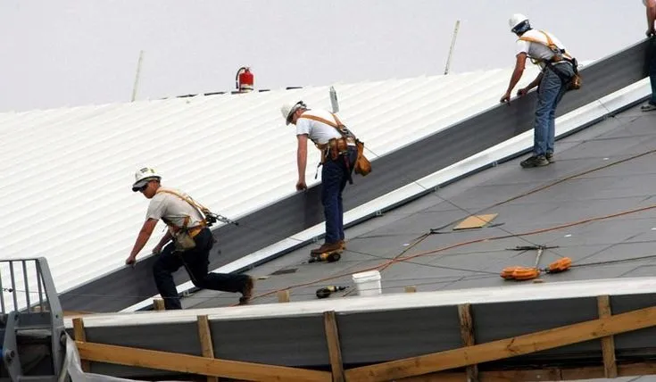 A team of roofing company working on the roof in Leander, TX