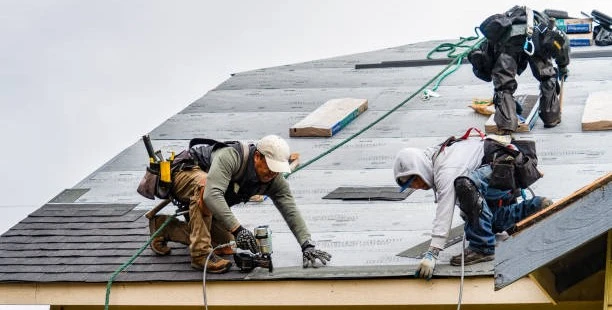 A team of roofing experts in Pflugerville working on a residential roof.