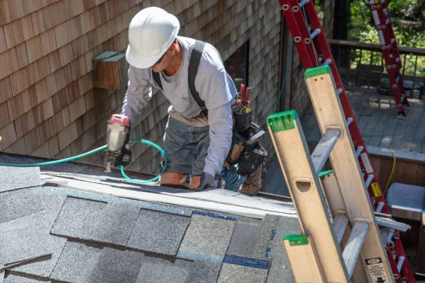 A skilled person is performing shingle roof installation services in Taylor, TX.