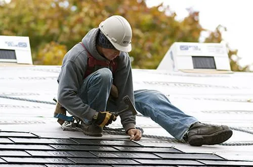 A skilled man is installing shingle roof in Manor, TX