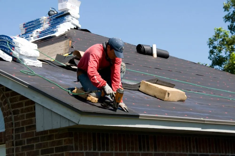 A skilled man is installing shingle roof in Leander, TX