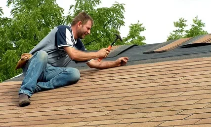 A roofer is performing shingle roof repair services which is a part of our Roof Replacement Services in Round Rock, TX.