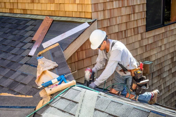 A professional roofer is performing shingle roof repair service in Hutto, TX