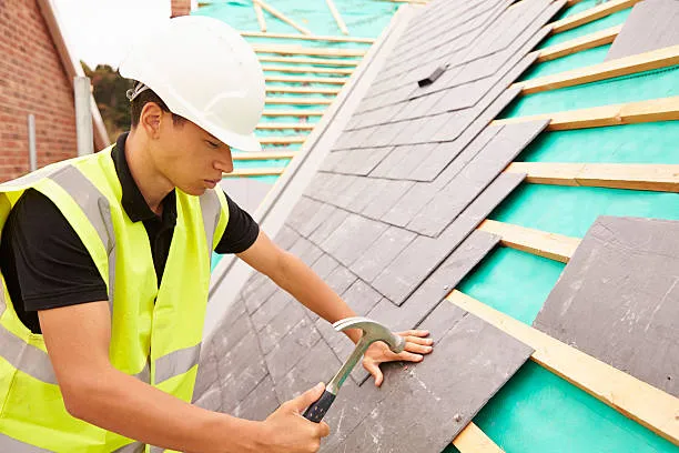 A skilled handyman is repairing shingle roof in Georgetown, TX