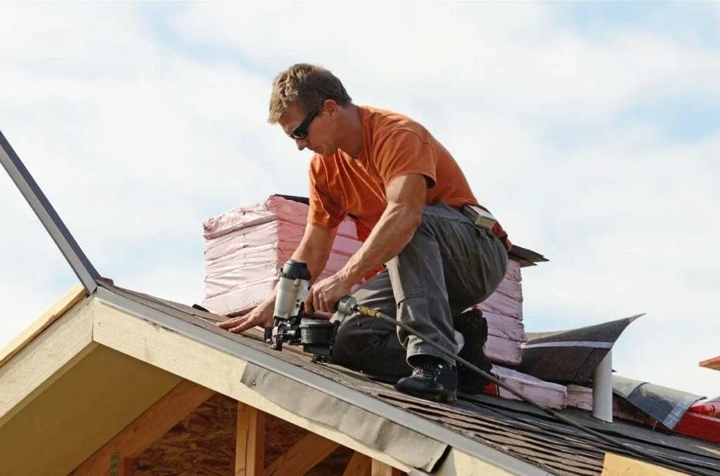 A professional roofer is repairing the shingle roof in Leander, TX