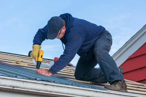 A worker is repairing shingles of roof in Cedar Park, TX.